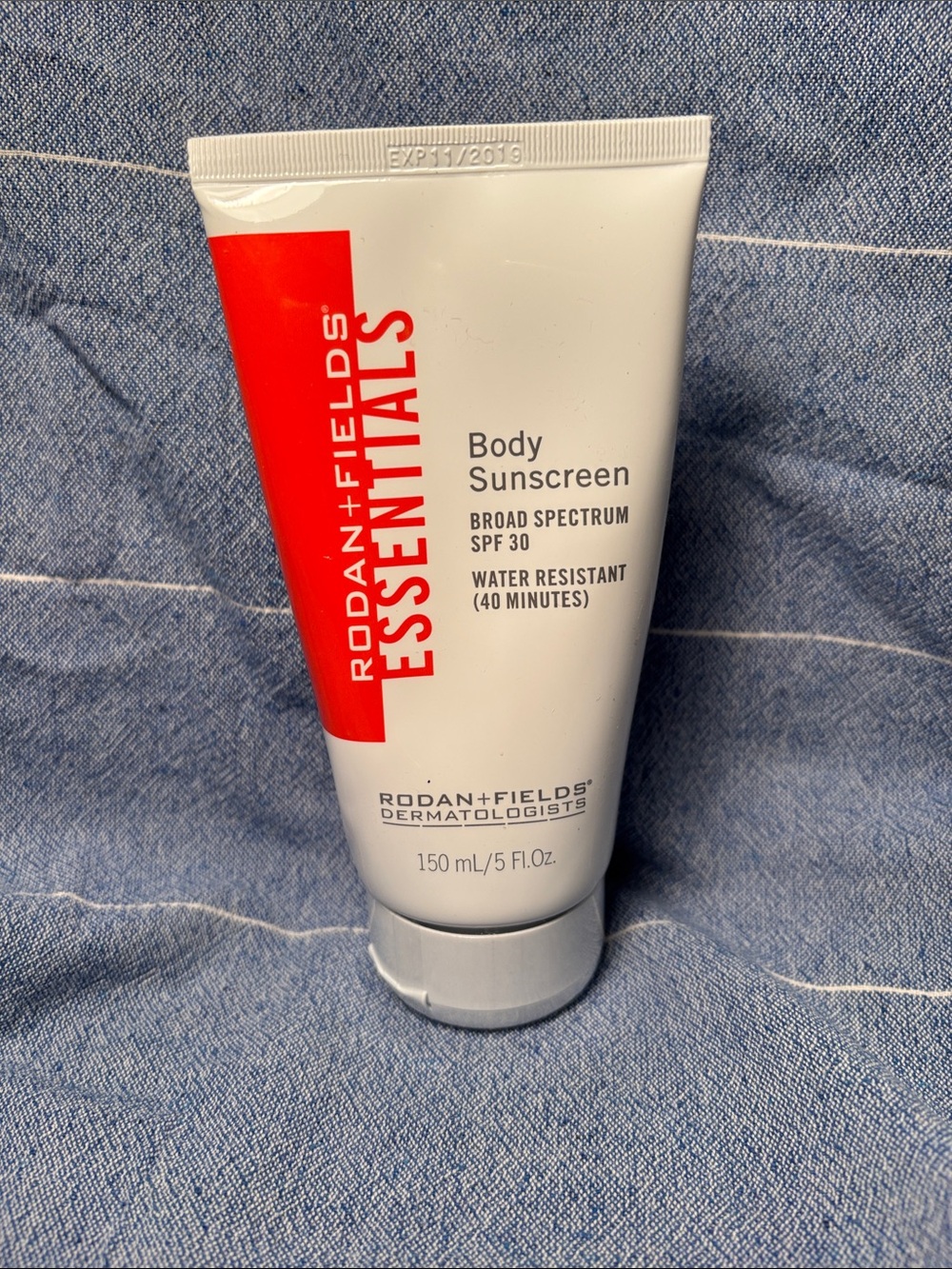 Rodan + Fields White Tube Sunscreen with Red Accent